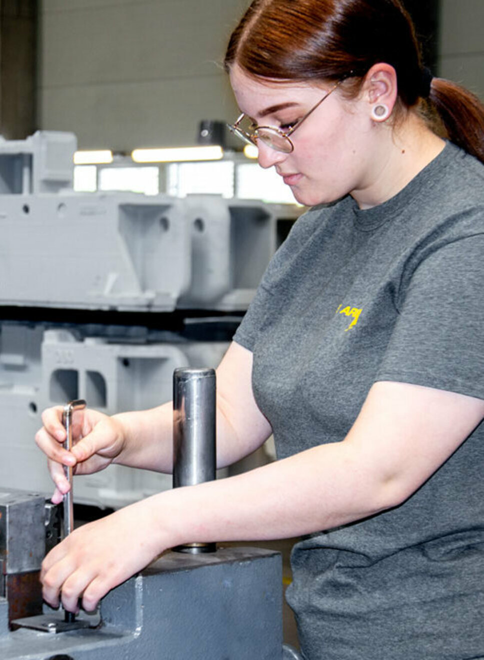 A young toolmaking technician is assembling stamping tools during her apprenticeship at weba Werkzeugbau in Steyr.